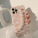 Casing ponsel HHPK21 warna pink dengan motif bunga dan tali. 