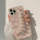 Casing ponsel HHPK21 warna pink dengan motif bunga dan tali. 